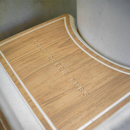 Wooden-like step with 'Cold Creek Tubs' branding on a white vertical tub.