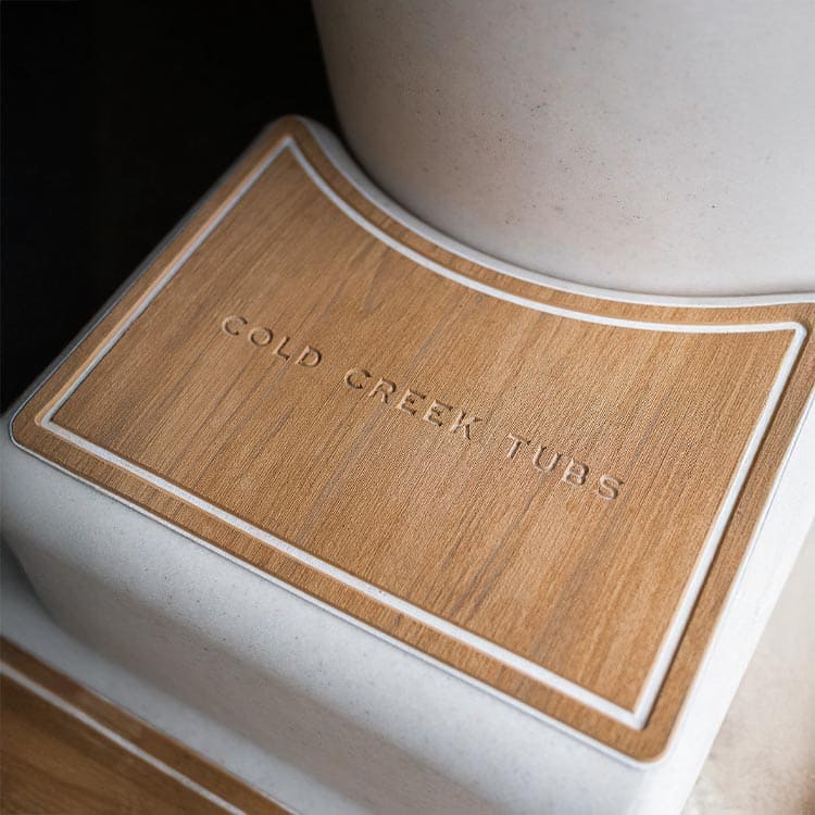 Close-up of a vertical tub with 'Cold Creek Tubs' branding on a wooden deck.