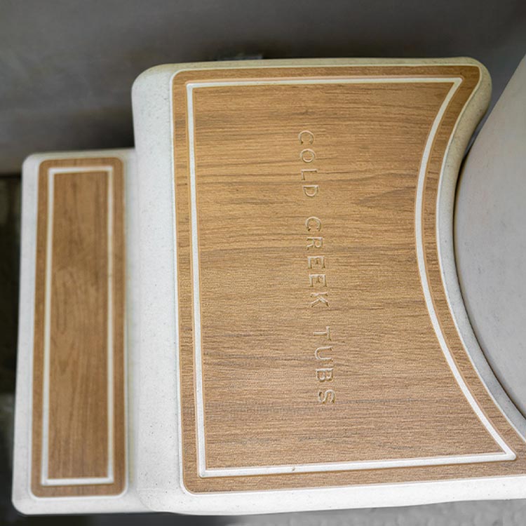 Wooden-like step with 'Cold Creek Tubs' branding on a neutral background
